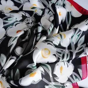 Fashionable floral silk-like scarf with large white flowers on a black background