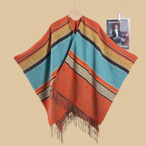 Detail shot of bohemian style shawl with ethnic patterns and vibrant fringe trim