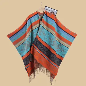 Close-up of bohemian knit shawl featuring ethnic patterns and fringe tassels