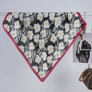 Floral print silk scarf in black with white flowers and vibrant red border design