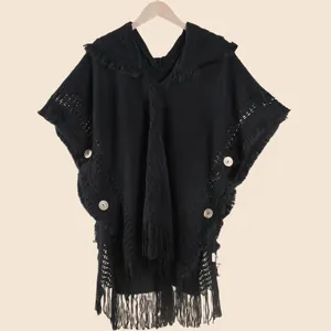 Women's black bohemian knit shawl with hood, decorative tassels and large buttons