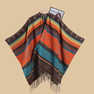 Detailed view of bohemian knit poncho featuring colorful geometric patterns and fringe tassels
