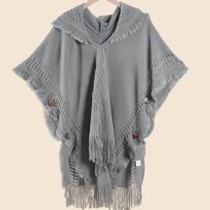 Women's gray knit hooded poncho with wooden buttons and bohemian fringe details