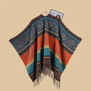 Close-up of bohemian knit poncho featuring vintage jacquard patterns and long tassel fringe