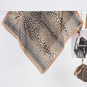 Detail showing the sheer texture and leopard print of the brown satin square scarf