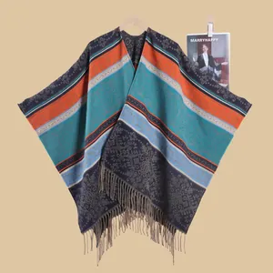 Close-up of bohemian colorful striped shawl with floral paisley patterns and tassel trim