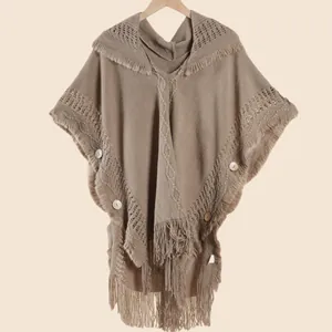 Detail of knit hooded poncho with bohemian fringe and vintage wooden buttons in khaki