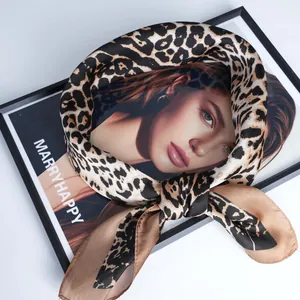 Chic leopard print satin scarf in a bow shape with glossy finish on a white background