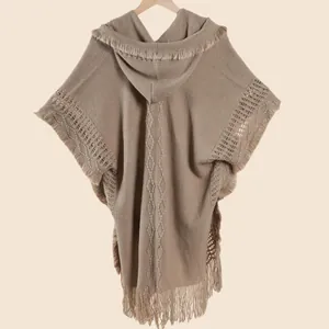 Detail of bohemian knit shawl with diamond patterns and delicate tassel trim