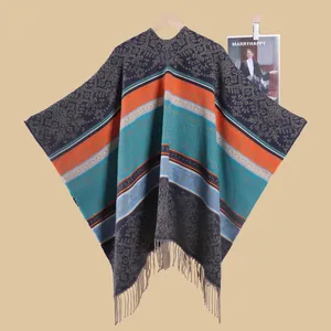 Detail of bohemian knit shawl with vintage floral patterns and fringe hem details