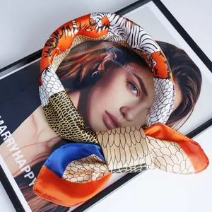 Silk-like satin scarf with vibrant zebra and tiger prints on a decorative art frame