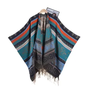 Ethnic knit poncho featuring colorful geometric patterns and decorative fringe tassels