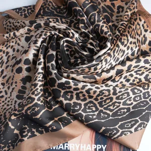 Brown leopard print satin square scarf for women shown in elegant spiral fold with silky texture