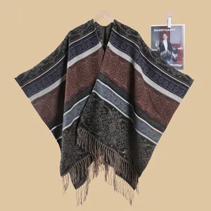 Detail of bohemian shawl with ethnic patterns, earth-tone stripes and long fringe tassels