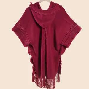 Close-up of wine red knitted shawl featuring bohemian tassels and diamond pattern texture
