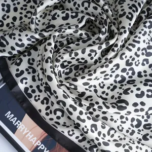 Classic black and white leopard print satin scarf with glossy texture on a fashion magazine