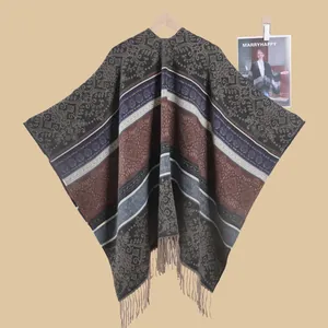 Detail of vintage ethnic jacquard shawl with paisley patterns and long tassel fringe
