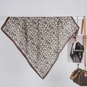 Close-up of leopard print satin scarf draped elegantly with luxury fashion accessories