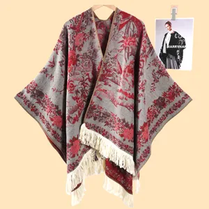 Close-up of ethnic floral knit shawl featuring thick texture and creamy white fringe trim