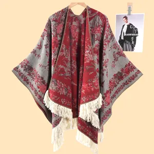 Detail of vintage floral jacquard knit shawl with fringes in red and grey colors