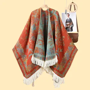Detail of vintage floral knit shawl with thick fabric texture and white fringe edges