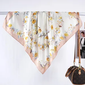 Détail d'un foulard en satin à fleurs avec fond crème élégant et texture soyeuse