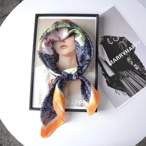 Vintage floral satin silk scarf with navy and orange patterns tied on a creative frame