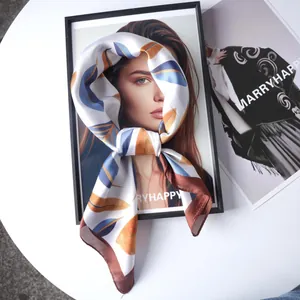 70cm satin silk square scarf featuring leaf prints and contrast hem on a portrait model