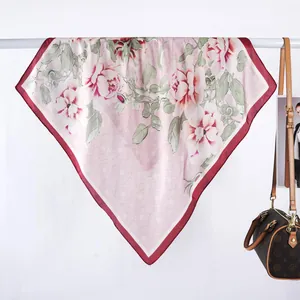 Close-up of vintage floral satin square scarf with red peony pattern and deep red border
