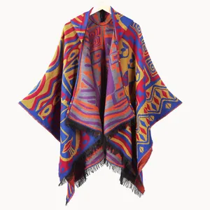 Women's hooded knit poncho with colorful geometric patterns and black tassels