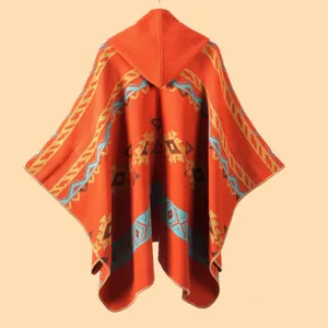 Ethnic bohemian hooded knit poncho cape with vibrant geometric patterns and tassels
