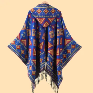 Detail of hooded cape showing ethnic geometric patterns and black fringe tassels