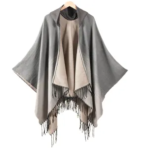 Women's hooded knit shawl wrap with beige gradient pattern and black fringe trim