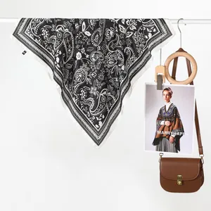 Exotic retro paisley flower silk scarf in black and white hanging on a white rack