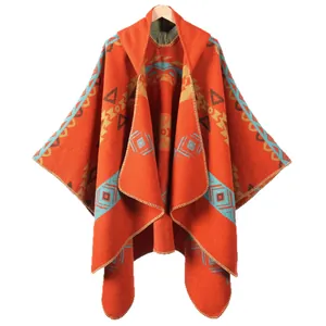 Ethnic hooded poncho for women with orange geometric patterns and tassel details