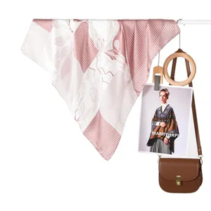 Carré de soie en satin rose et blanc avec croquis floraux et rayures sur un support