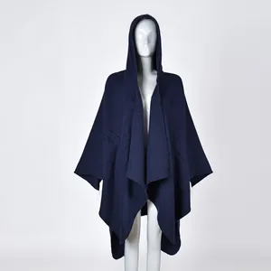 Detail of navy blue hooded cape shawl with thick knit texture and fine overlock edge stitching