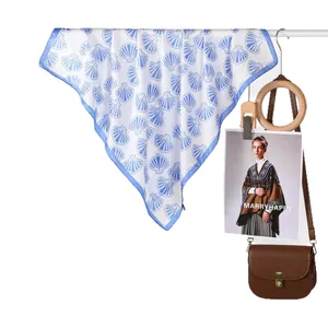Blue shell print silk scarf for women on white background with elegant accessories