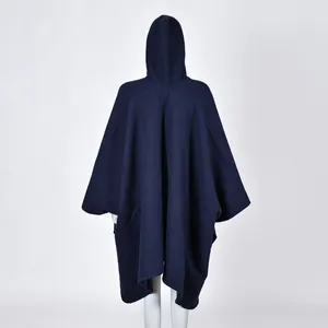 Detailed back view of a navy blue hooded poncho shawl in thick knitted wool blend fabric