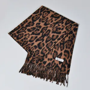 Detail of classic leopard print scarf featuring soft fringe and Pashmina fabric texture