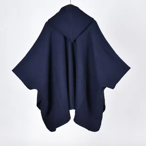 Detailed view of dark blue hooded shawl cape with refined edge stitching and thick fabric