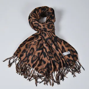 Soft 100% cashmere scarf with classic leopard print and fringe, folded on grey background