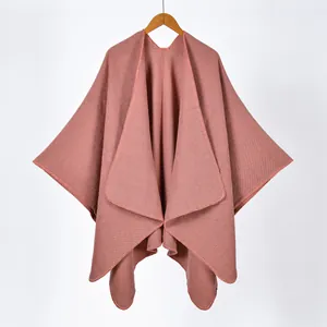 Detail view of the fine knit texture and neat edge stitching on the rose pink poncho shawl