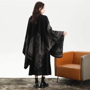 Back view of elegant black knit shawl with grey landscape patterns and asymmetric hem
