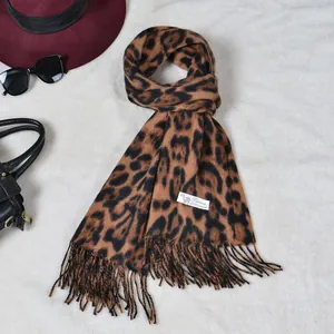 Close-up of leopard print cashmere scarf with fringe details and woven label