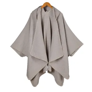 Solid color hooded knitted poncho cape for women with side slits and textured knit finish