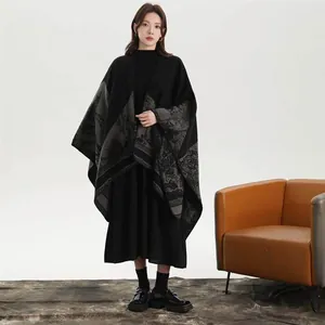 Detail of high-end knitted shawl featuring elegant grey landscape patterns on black fabric