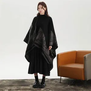 Detail of elegant black knitted shawl with grey mountain print for women's winter fashion