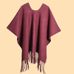 Detail of burgundy shawl cape featuring elegant long fringe tassels and premium thick texture