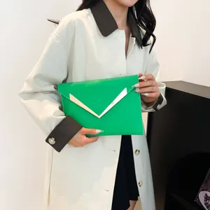 Bright green sequined envelope clutch with golden V-metal accent and quilted pattern